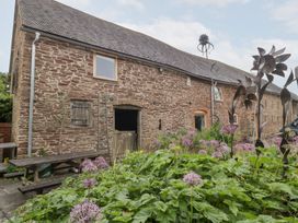 A stone building with flowers in the garden at The Art House Leominster