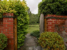 A pathway leading through a gate in a garden at The Art House in Leominster