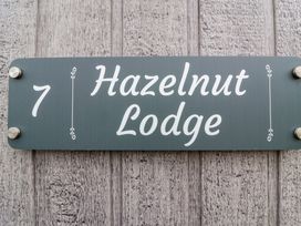 A house sign displaying the number 7 and Hazelnut Lodge at Hazelnut Lodge in Chipping Norton