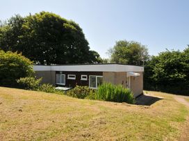 A house with windows and greenery at 8 Hillside Bude