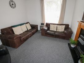 A living room with sofas and a clock at Georgian Town House Whitehaven