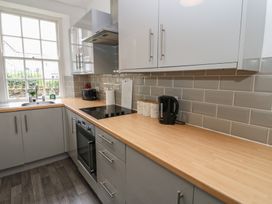 A kitchen with appliances and a sink at Georgian Town House in Whitehaven