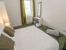 A bedroom with a bed and a desk at Georgian Town House in Whitehaven
