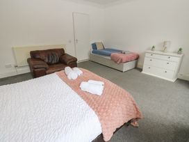 A bedroom with a bed, sofa and dresser at Georgian Town House in Whitehaven
