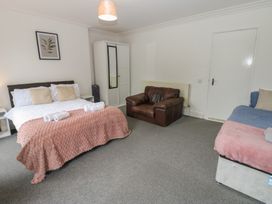 A bedroom with a bed and sofa at Georgian Town House in Whitehaven