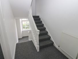 A staircase with a window and radiator at Georgian Town House in Whitehaven