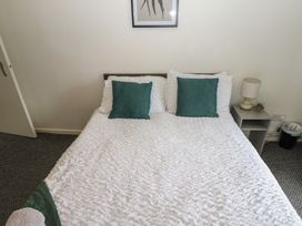 A bedroom with a bed and bedside lamp at Georgian Town House Whitehaven