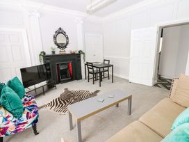 A living room with a sofa and a coffee table at Lowther Suite in Whitehaven