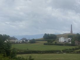 A view of houses and a monument on a hill at The Gatekeepers Cottage - Skerry Vore Bryn Pydew near Llandudno Junction
