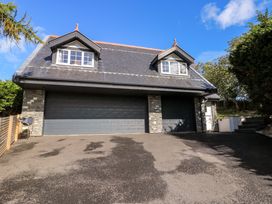 A house with two garages and a pathway at The Gatekeepers Cottage - Skerry Vore in Bryn Pydew near Llandudno Junction