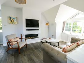 A living room with a sofa and a coffee table at The Gatekeepers Cottage - Skerry Vore, Bryn Pydew near Llandudno Junction
