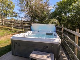 A hot tub with water at The Gatekeepers Cottage - Skerry Vore Bryn Pydew near Llandudno Junction