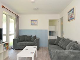 A living room with a sofa and coffee table at 4 Rosecraddoc Lodge Holiday Bungalows in Liskeard