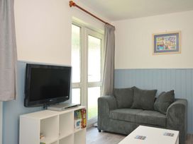 A living room with television and sofa at 4 Rosecraddoc Lodge Holiday Bungalows Liskeard