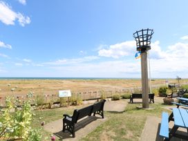 A seating area with benches near the sea at No. 2 - Seaview, Kessingland
