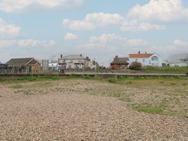 A pebble beach with houses and road at No. 2 - Seaview in Kessingland