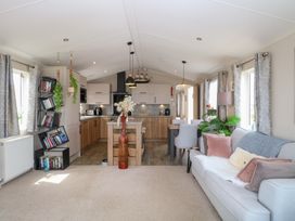 A living room with furniture and kitchen area at No. 2 - Seaview Kessingland