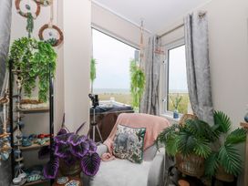 A snug with plants and a window overlooking the sea at No. 2 - Seaview in Kessingland