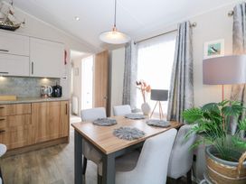 A dining room with a table and chairs at No. 2 - Seaview Kessingland