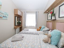 A bedroom with twin beds and a wardrobe at No. 2 - Seaview Kessingland