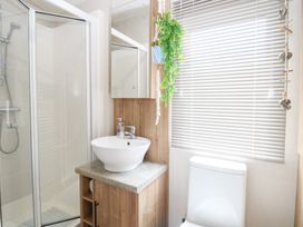 A bathroom with a shower, sink and toilet at No. 2 - Seaview in Kessingland