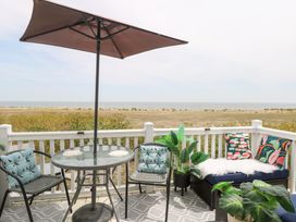An outdoor patio with a table and chairs at No. 2 - Seaview in Kessingland