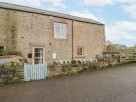 A stone building with windows and a door at Watermill Cottage in North Charlton