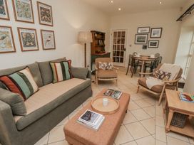 A living room with a sofa and coffee table at Watermill Cottage North Charlton