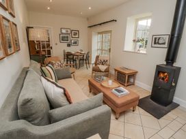 A living room with a sofa and coffee table at Watermill Cottage in North Charlton