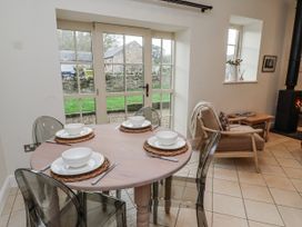 A dining area with a table set for four at Watermill Cottage in North Charlton