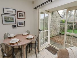 A dining room with a table set for meals at Watermill Cottage in North Charlton