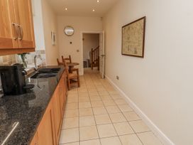 A kitchen with a countertop and dining table at Watermill Cottage in North Charlton