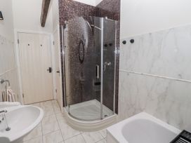 A bathroom with a shower and sink at Watermill Cottage in North Charlton