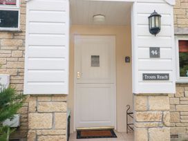 An entryway with a front door and a light fixture at Trouts Reach in Falmouth
