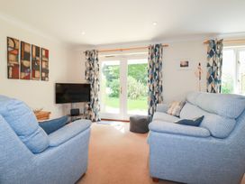 A living room with two sofas and a television at Trouts Reach in Falmouth