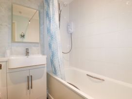 A bathroom with a sink, bathtub, and shower at Trouts Reach in Falmouth