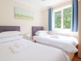 A bedroom with two beds and a window at Trouts Reach in Falmouth