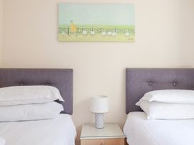 A bedroom with two beds and a nightstand at Trouts Reach in Falmouth