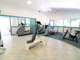 A gym with various exercise equipment at Trouts Reach in Goldenbank near Budock Water