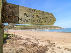 A sign directing to Mawnan Church from the coast path at Trouts Reach in Goldenbank near Budock Water