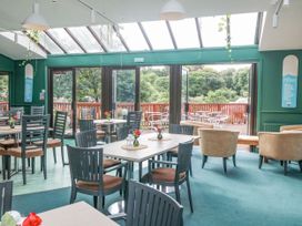 A dining room with tables and chairs at Trouts Reach in Goldenbank near Budock Water