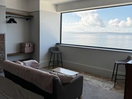 A living room with a view of the sea at Mostyn View in West Kirby