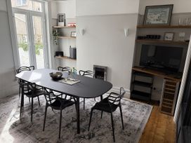 A dining room with a table and chairs at Mostyn View in West Kirby