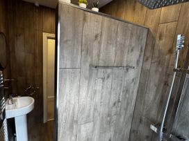 A bathroom with a shower and sink at Mostyn View in West Kirby