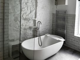 A bathroom with a bathtub and a shower at Mostyn View in West Kirby