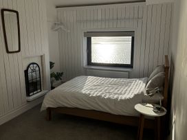 A bedroom with a bed and window at Mostyn View in West Kirby