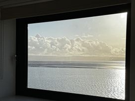 A view of clouds over the ocean through a window at Mostyn View in West Kirby