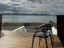 An outdoor area with chairs and a view of the water at Mostyn View in West Kirby