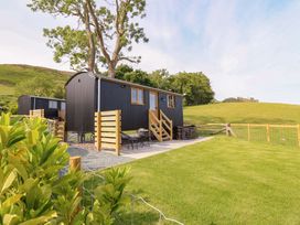 A cabin with stairs and outdoor seating at Defaid Cymreig Oswestry