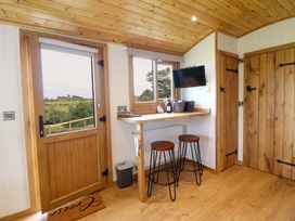 A snug with a bar and two stools at Defaid Cymreig in Oswestry